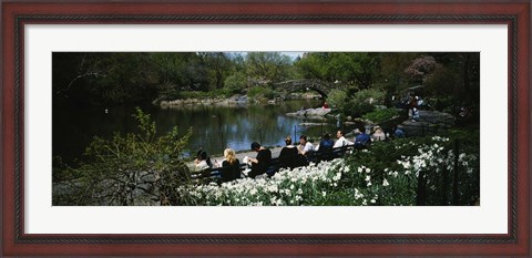 Framed Group of people sitting on benches near a pond, Central Park, Manhattan, New York City, New York State, USA Print