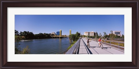 Framed Bicyclists along the Sacramento River with Tower Bridge in background, Sacramento, Sacramento County, California, USA Print