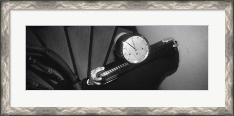 Framed Man Carrying Clock Up Stairs On Shoulders Print