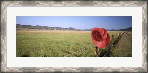 Framed USA, California, Red cowboy hat hanging on the fence Print
