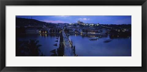 Framed High angle view of buildings lit up at dusk, Charles Bridge, Vltava River, Prague, Czech Republic Print