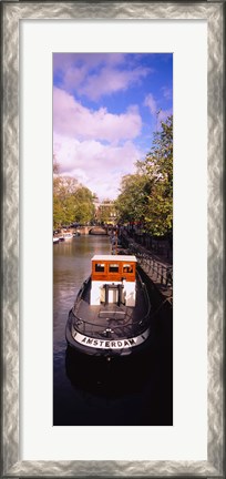 Framed Tourboat docked in a channel, Amsterdam, Netherlands Print