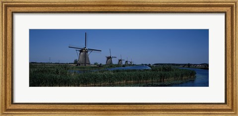 Framed Traditional windmills at a riverbank, Kinderdijk, Rotterdam, Netherlands Print