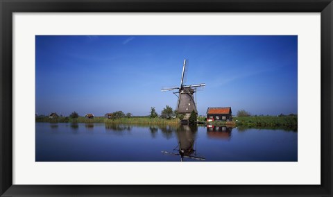 Framed Reflection of a traditional windmill in a lake, Netherlands Print