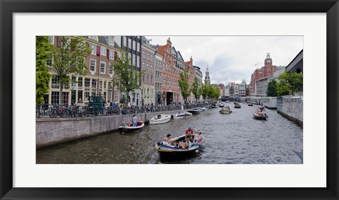 Framed Tourboats in a canal, Amsterdam, Netherlands Print