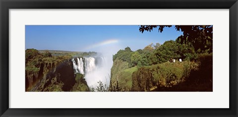 Framed Tourists at a viewing point looking at the rainbow formed over Victoria Falls, Zimbabwe Print