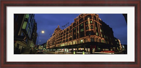 Framed Low angle view of buildings lit up at night, Harrods, London, England Print