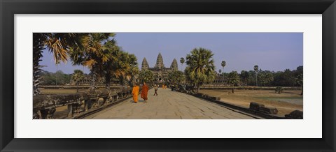 Framed Two monks walking in front of an old temple, Angkor Wat, Siem Reap, Cambodia Print