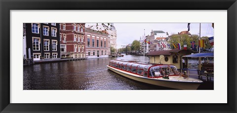 Framed Tourboat in a channel, Amsterdam, Netherlands Print
