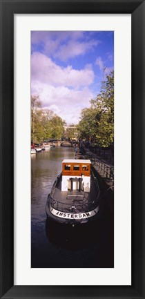 Framed Tourboat docked in a channel, Amsterdam, Netherlands Print