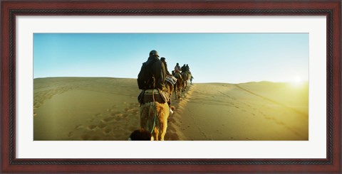Framed Row of people riding camels through the desert, Sahara Desert, Morocco Print