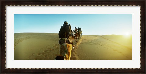 Framed Row of people riding camels through the desert, Sahara Desert, Morocco Print