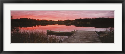 Framed Canoe tied to dock on a small lake at sunset, Sweden Print