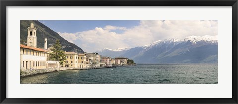 Framed Buildings at the waterfront with snowcapped mountain in the background, Gargnano, Monte Baldo, Lake Garda, Lombardy, Italy Print