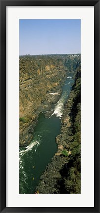 Framed Kayakers paddle down the Zambezi gorge away from the Victoria Falls, Zambia Print