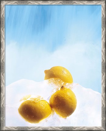 Framed Three lemons frozen in ice below ice blue sky Print