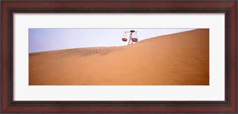 Framed Low angle view of a woman carrying panniers, Mui Ne, Vietnam Print