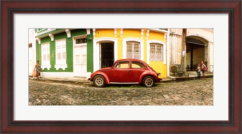 Framed Small old red car parked in front of colorful building, Pelourinho, Salvador, Bahia, Brazil Print