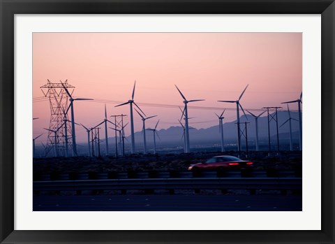 Framed Car moving on a road with wind turbines in background at dusk, Palm Springs, Riverside County, California, USA Print