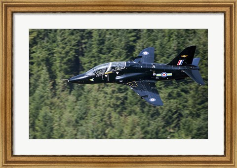 Framed Hawk T1 trainer aircraft of the Royal Air Force flying over a forest in North Wales Print