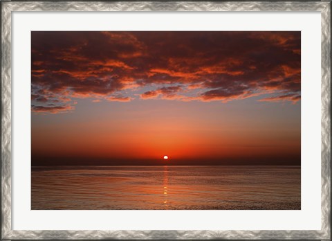 Framed layer of clouds is lit by the rising sun over Rio de la Plata, Buenos Aires, Argentina Print