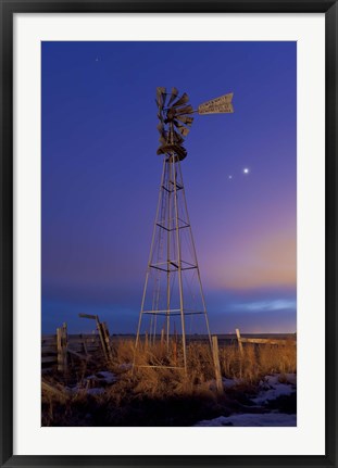 Framed Venus and Jupiter are visible behind an old farm water pump windmill, Alberta, Canada Print