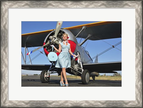 Framed Elegant 1940&#39;s style pin-up girl standing in front of an F3F biplane Print