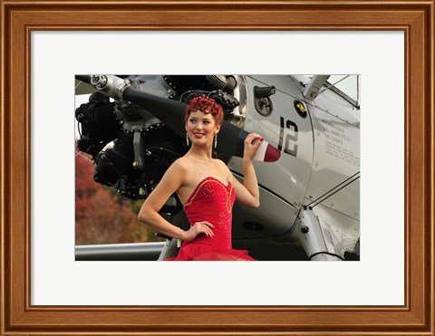 Framed Redhead pin-up girl in 1940&#39;s style dancer attire holding on to a vintage aircraft propeller Print