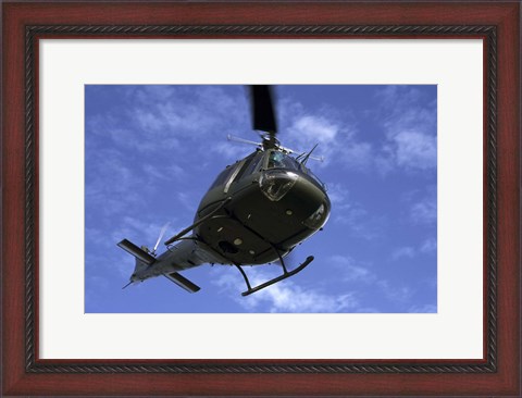 Framed Former US Air Force Bell UH-1E Huey helicopter in flight Print