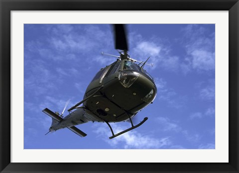 Framed Former US Air Force Bell UH-1E Huey helicopter in flight Print