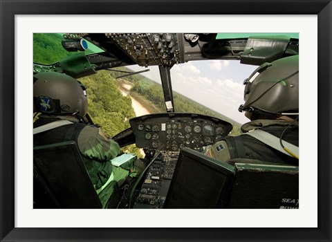 Framed Two instructor pilots practice low flying operations in a UH-1H Huey helicopter Print