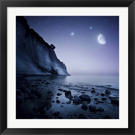 Framed Rising moon over ocean and mountains against starry sky Print