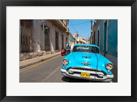 Framed Cuba, Camaquey, Oldsmobile car and buildings Print