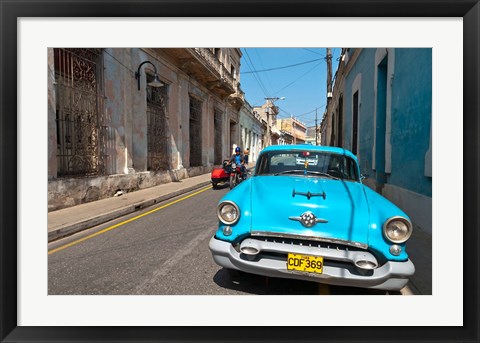 Framed Cuba, Camaquey, Oldsmobile car and buildings Print