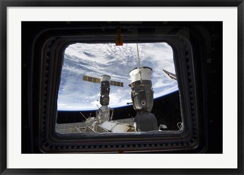 Framed Two Russian Spacecraft Docked with the International Space Station, as seen from Space Shuttle Discovery&#39;s Flight Deck Window Print