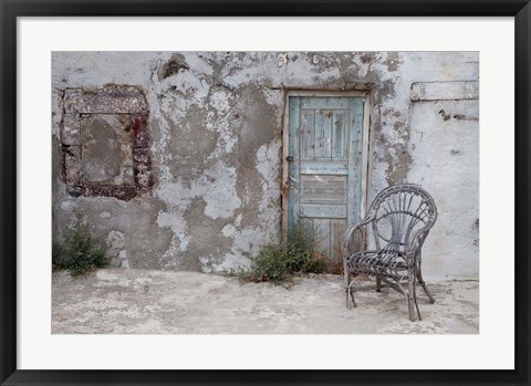 Framed Old Building chair and doorway in town of Oia, Santorini, Greece Print