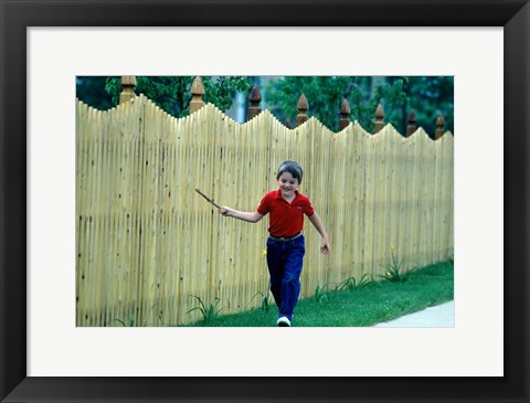Framed 1980s Smiling Boy Running Along Sidewalk Print