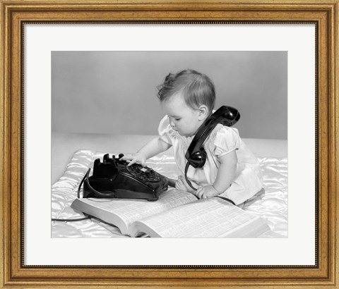 Framed 1960s Baby Girl With Telephone Book Print