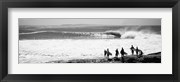 Silhouette of surfers standing on the beach, Australia (black and white)