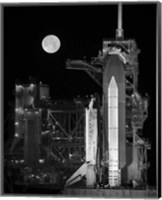 Framed Space Shuttle Discovery Sits Atop the Launch Pad With a Full Moon in Background
