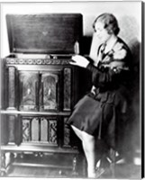 Framed Young woman sitting beside an RCA Radio-Phonograph and Home Recorder