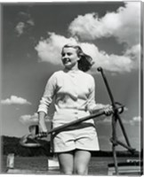 Framed Young woman standing on boat, holding anchor
