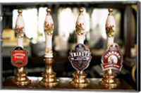 Framed Close-up of beer tap handles in a bar, London, England