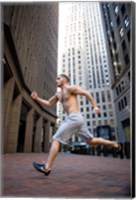 Framed Side profile of a young man running in a city