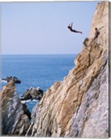 Framed Male cliff diver jumping off a cliff, La Quebrada, Acapulco, Mexico