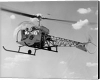 Framed Low angle view of two people sitting in a helicopter, Bell 47G-2