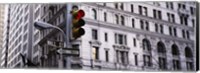 Framed Low angle view of a Red traffic light in front of a building, Wall Street, New York City