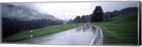 Framed Wet highway passing through a forest, Austria