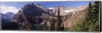 Framed Trees with a mountain range in the background, US Glacier National Park, Montana, USA