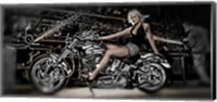 Framed Female model with a motorcycle in a workshop